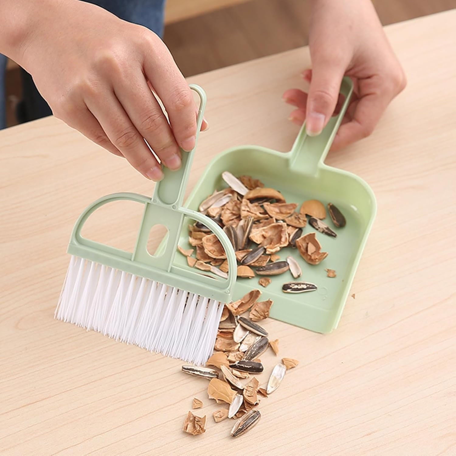 Wukusy 2-in-1 handheld cleaning dustpan with ergonomic handle and compact design for easy sweeping and debris collection.