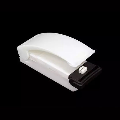 Wukusy 7675a multifunctional portable plastic bag sealer sealing a plastic bag for household use.