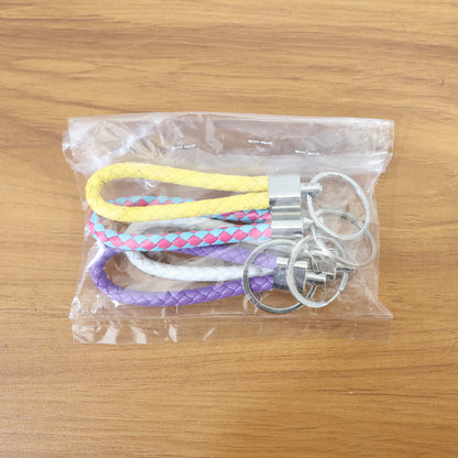 Set of four braided loop keychains by Wukusy, featuring colorful woven designs and sturdy metal keyring attachments.