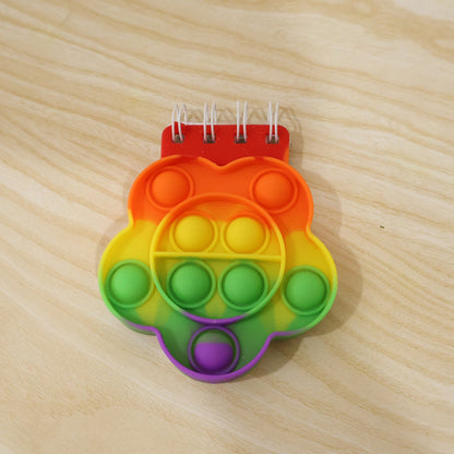 Colorful Rainbow Push Bubble Pop It Diary for kids, silicone fidget notebook with rainbow design, by Wukusy.
