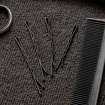 Set of 24 black Wukusy hair bobby pins, neatly arranged on a white background, ideal for securing hair styles.