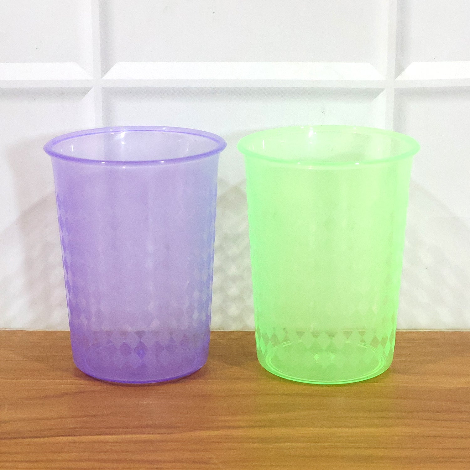 Reusable plastic drinking glass, 200 ml, in mixed colors by Wukusy, shown with a clear view of the colorful design and shape.
