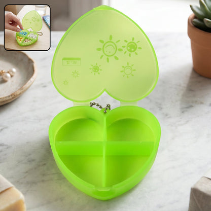 Wukusy plastic heart-shaped pill organizer with four compartments and keychain for portable medication storage.