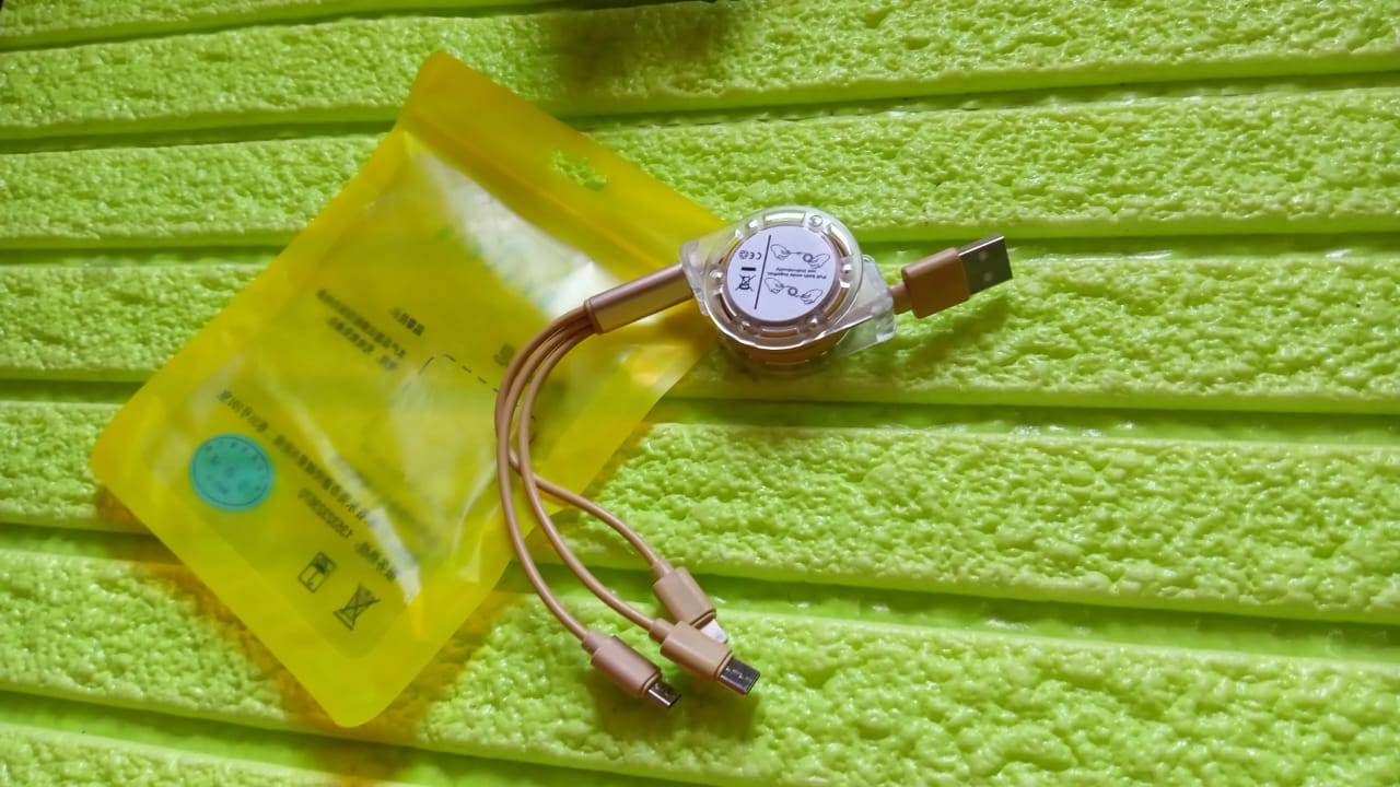 Wukusy 12835 retractable 3-in-1 Micro USB, Type C, and Android charging cable coiled with connectors for mobile devices.