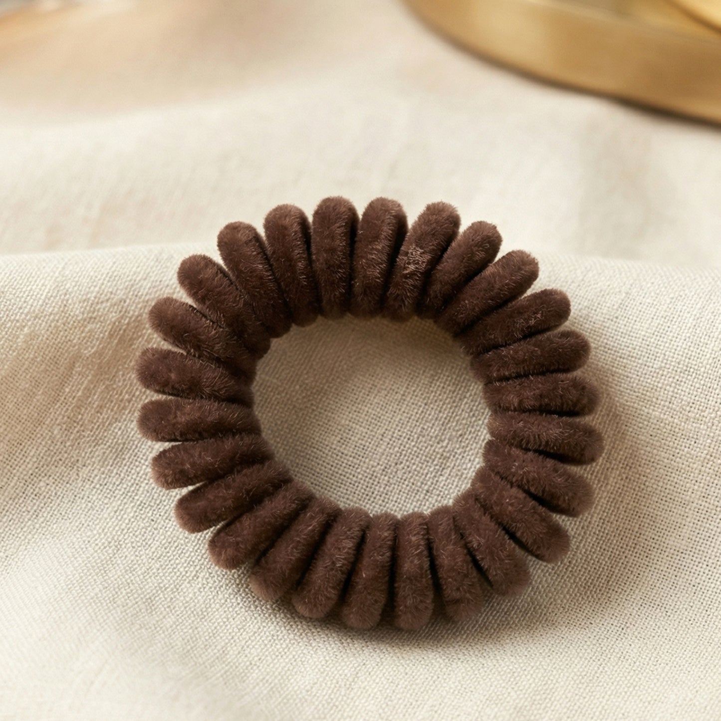 Soft stretchable telephone wire style hair band from Wukusy, shown in black, with a flexible, thin, and durable design for hair styling.