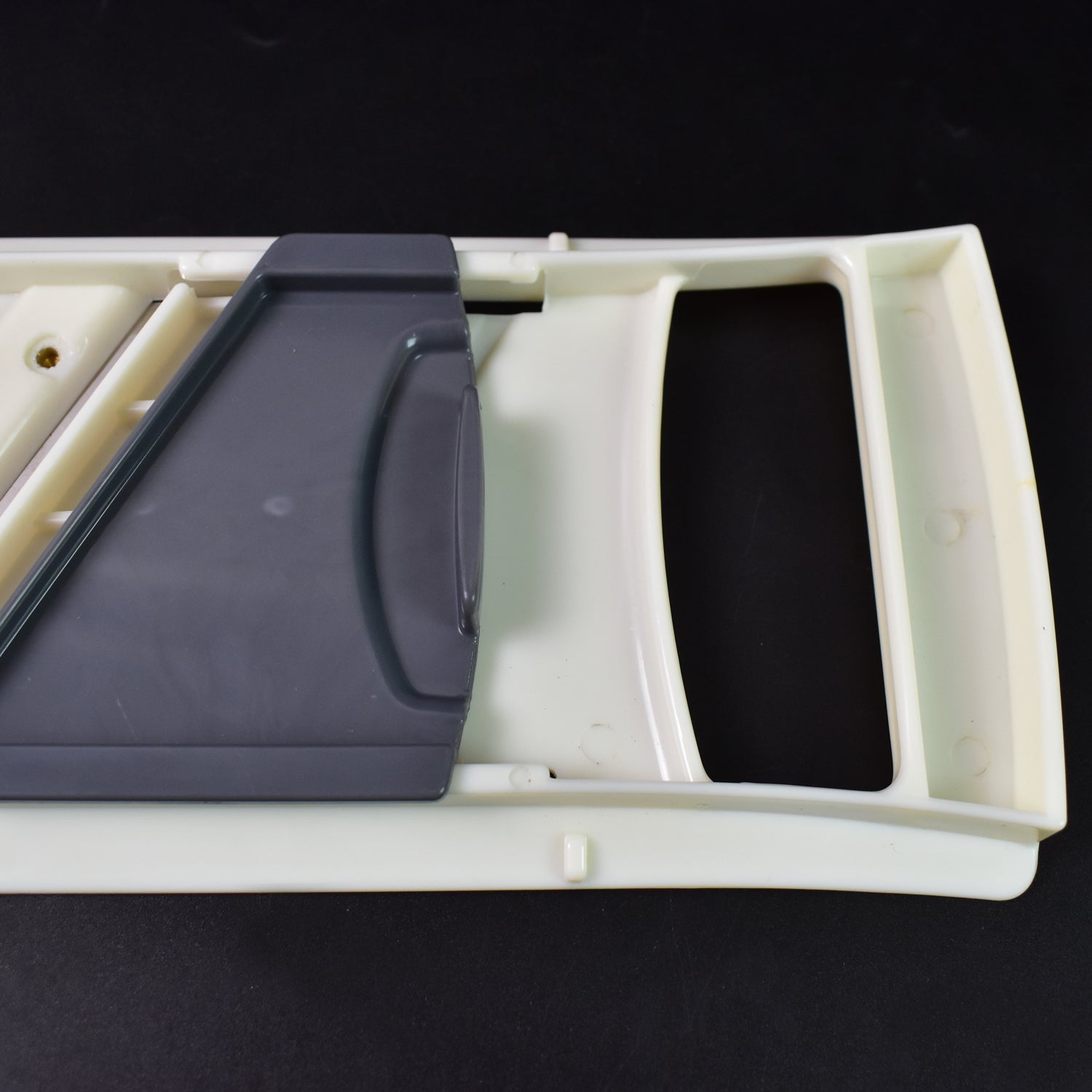 Wukusy adjustable fruit and vegetable slicer with stainless steel blades on a kitchen countertop, ready for food preparation.