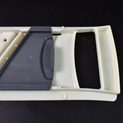 Wukusy adjustable fruit and vegetable slicer with stainless steel blades on a kitchen countertop, ready for food preparation.