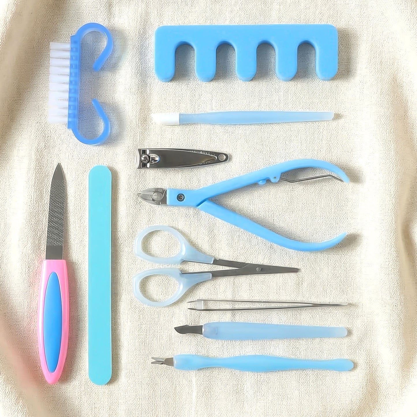 Wukusy 11-in-1 manicure and pedicure nail care kit with various tools arranged in a compact set for personal grooming.