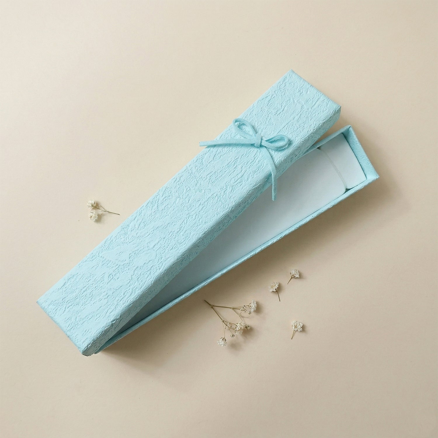 Elegant Wukusy long rectangular jewelry gift box with a decorative ribbon, perfect for presenting jewelry gifts.
