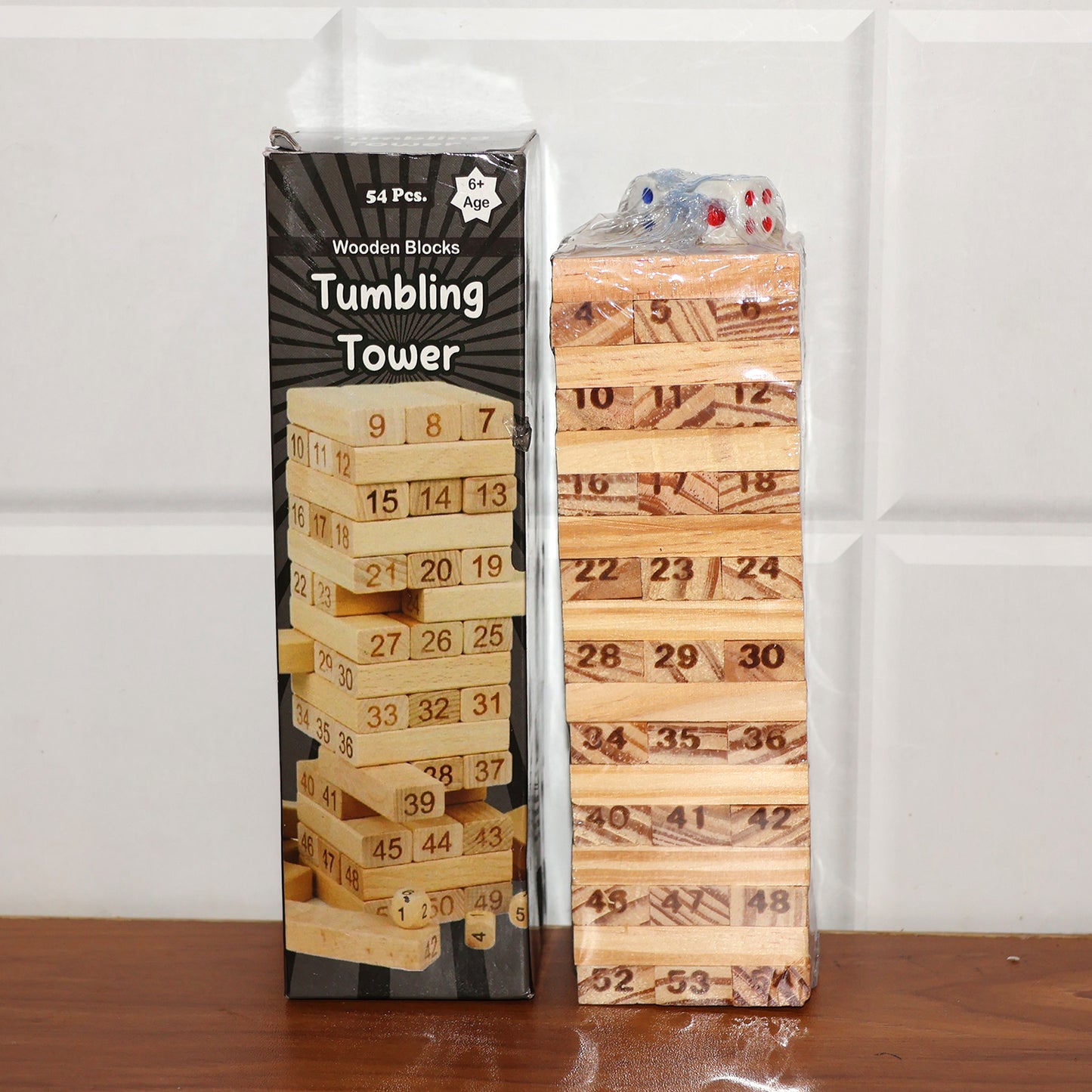 Wooden tumbling tower game set by Wukusy with stacked wooden blocks for stacking and balancing play.