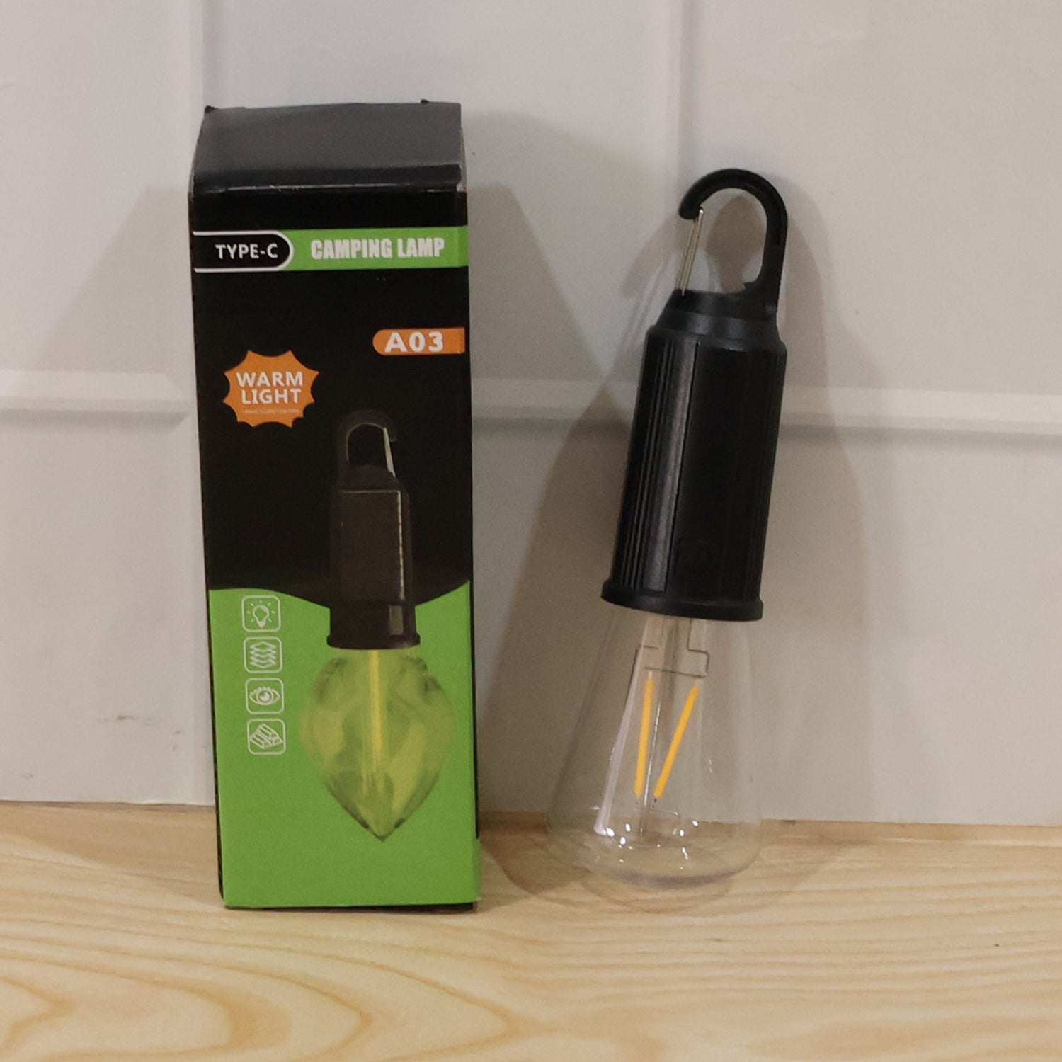 Wukusy solar rechargeable camping lamp LED bulb with warm light and hook for portable outdoor lighting, shown with attached hook
