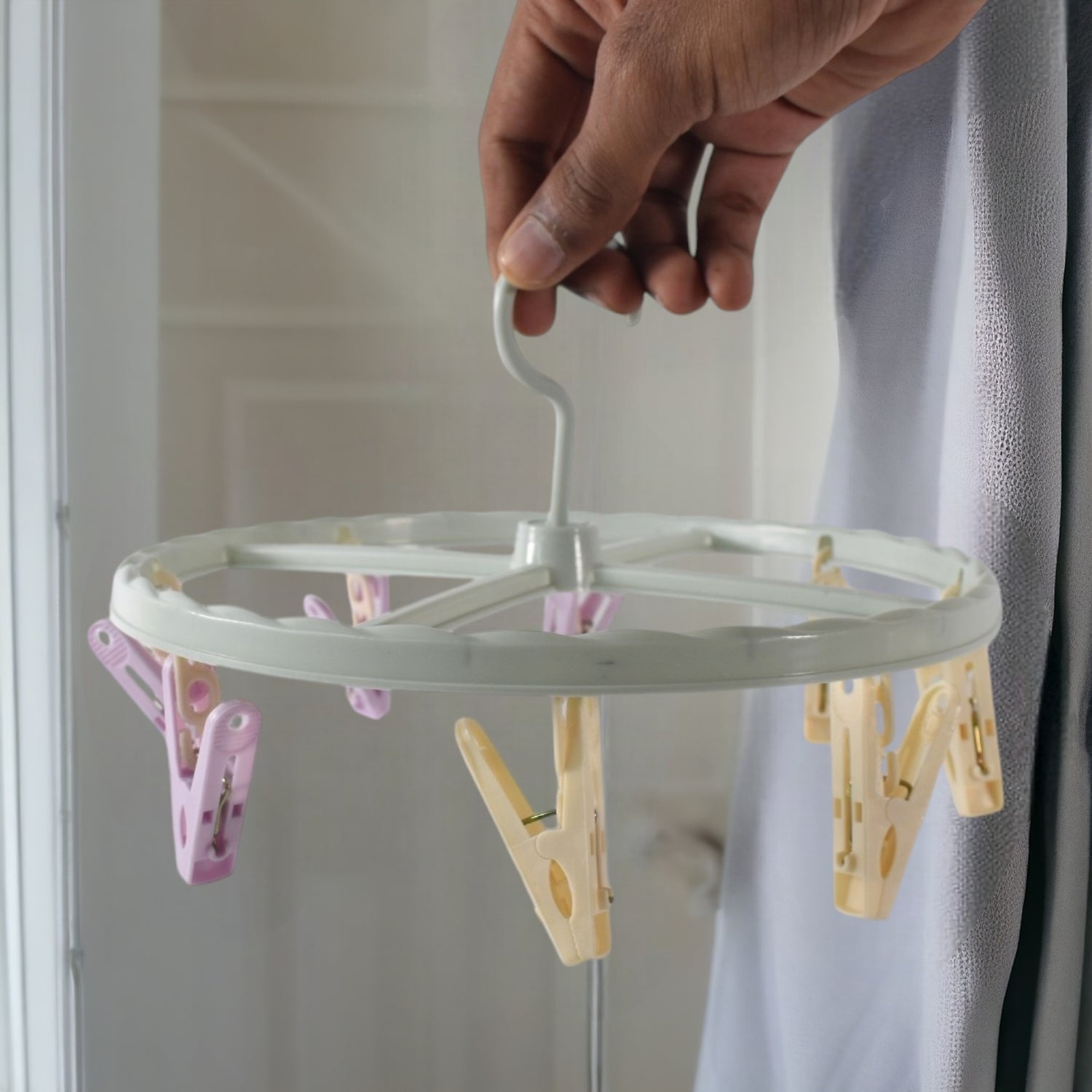 Wukusy clothespin rack laundry drying rack with multiple metal bars for hanging clothes and clothespins in a home laundry room