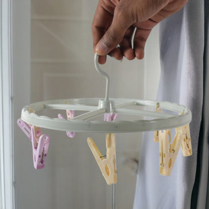Wukusy clothespin rack laundry drying rack with multiple metal bars for hanging clothes and clothespins in a home laundry room