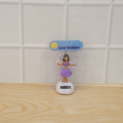 Wukusy solar-powered dancing hula doll bobble toy for car dashboard decor, featuring a colorful hula dancer with a grass skirt and floral accessories.