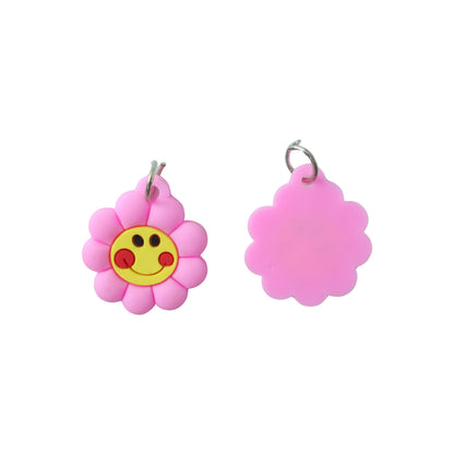 Set of 10 Wukusy smiley flower-shaped bag charm keychains with colorful, cheerful designs on a white background