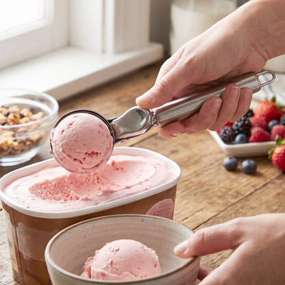 Wukusy stainless steel trigger release ice cream scoop and cookie dough scooper showing its ergonomic handle and shiny metal bowl.