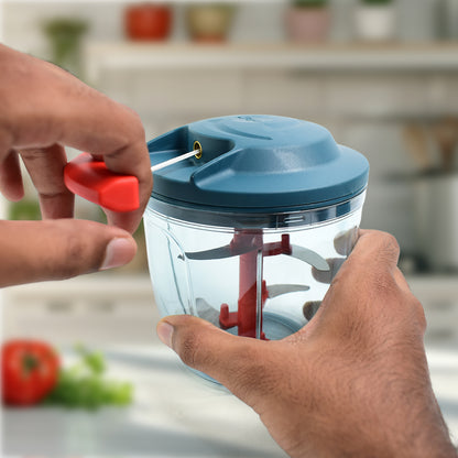 Wukusy Apex Speed-x hand-powered vegetable chopper with 1000 ml capacity, shown with chopped vegetables in the container