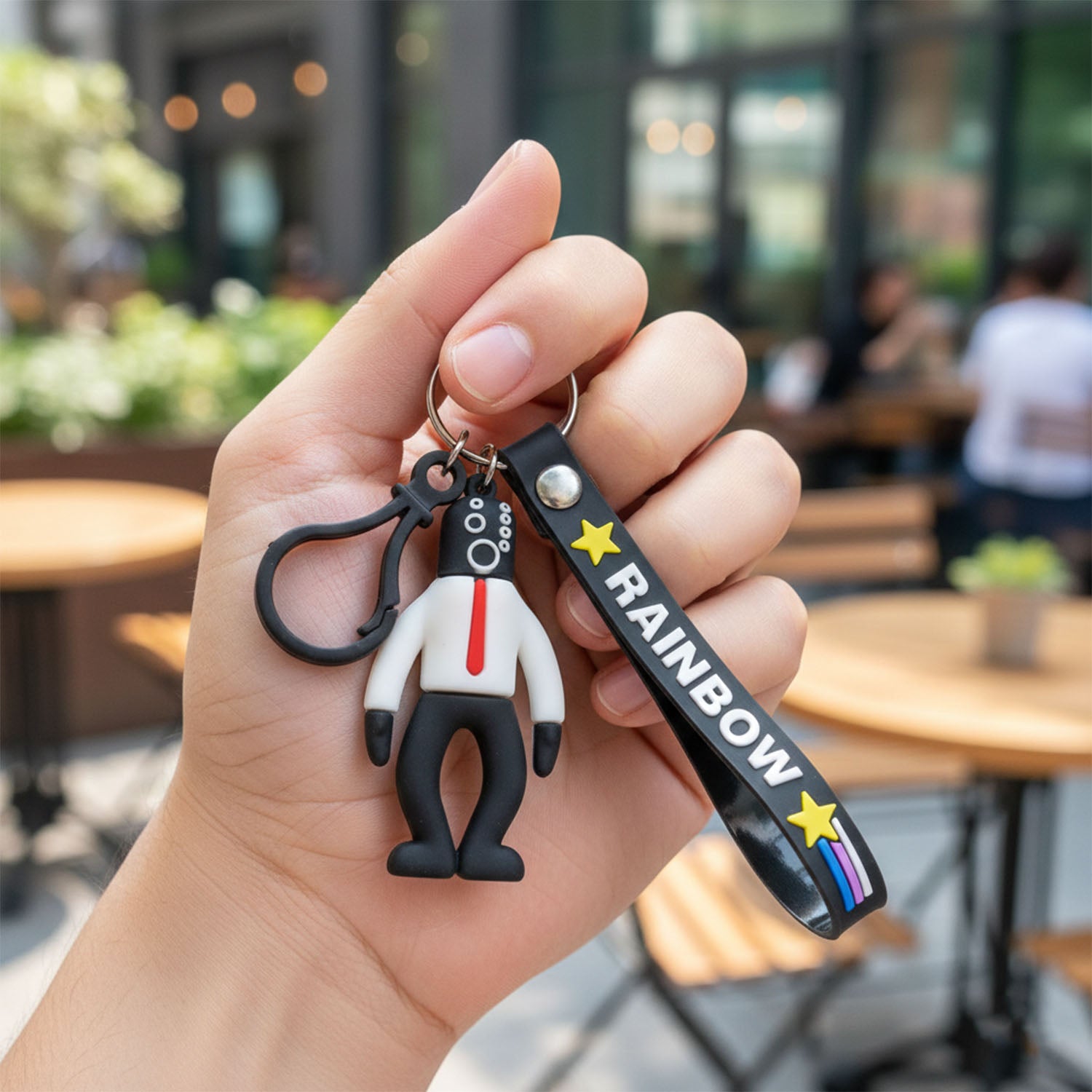 Wukusy cartoon man figure keychain featuring a colorful, playful design with a smiling face and detailed clothing.