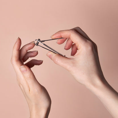 Stainless steel Wukusy nail clipper with nail catcher and file, compact and ergonomic for precise nail grooming.