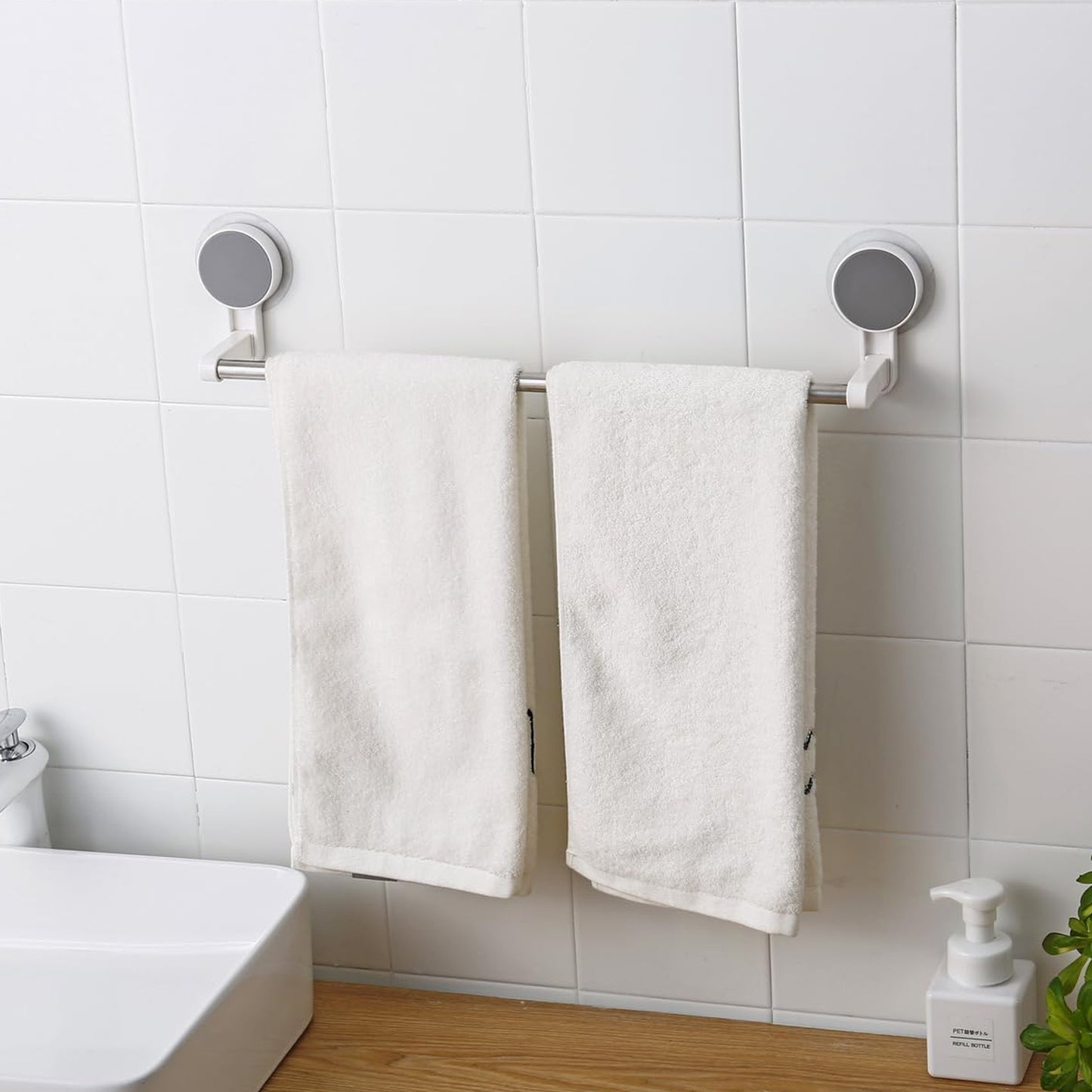 Wukusy self-adhesive towel rod rack mounted on bathroom wall, showing sleek design and easy installation for towel hanging.