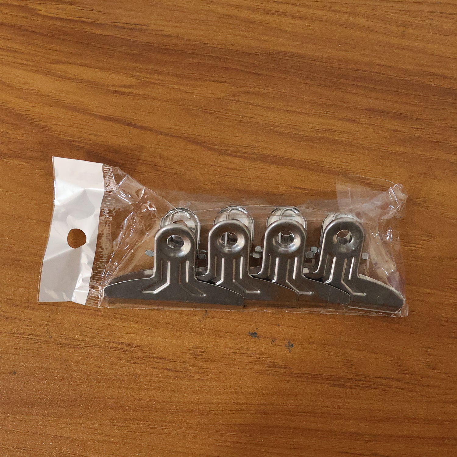 Set of four heavy-duty metal paper clamp clips by Wukusy, showing sturdy metal clips with spring-loaded grips for secure paper holding.