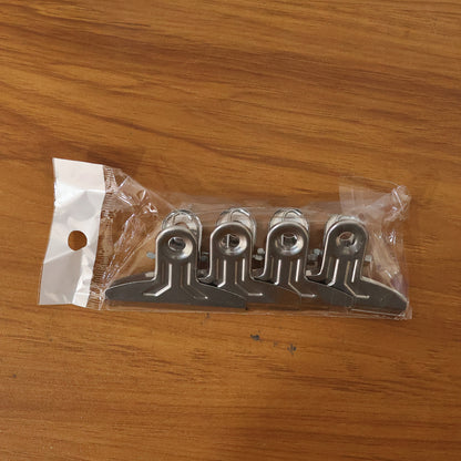 Set of four heavy-duty metal paper clamp clips by Wukusy, showing sturdy metal clips with spring-loaded grips for secure paper holding.