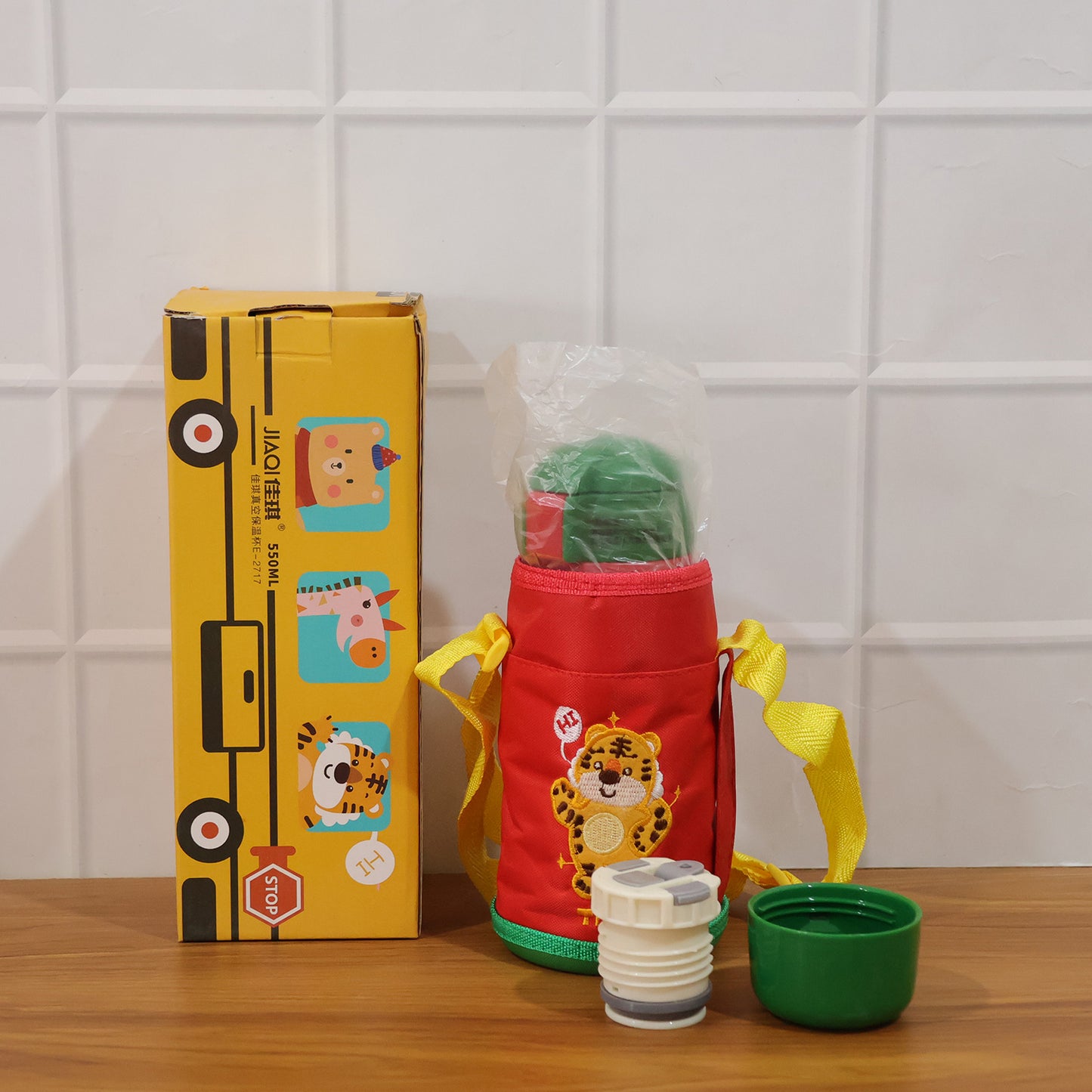 Kids cartoon printed water bottle by Wukusy, 550 ml capacity with straw and carry sling bag for children.