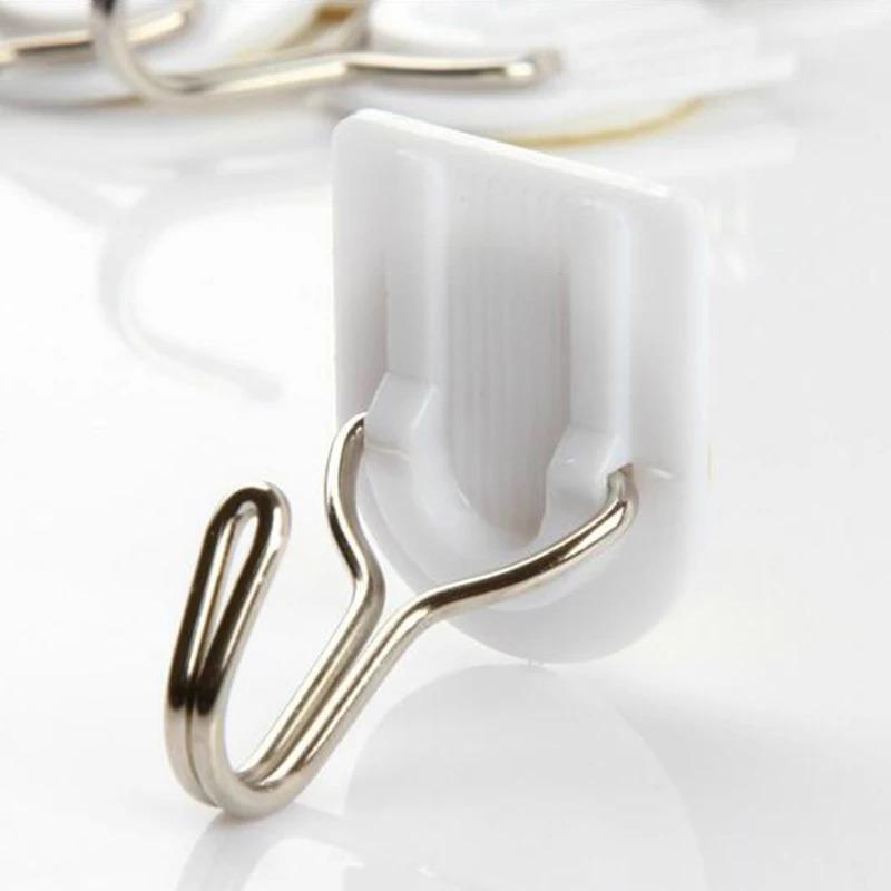 Wukusy 1627 adhesive ABS plastic hook towel hanger for kitchen and bathroom, mounted on a wall for convenient towel hanging.