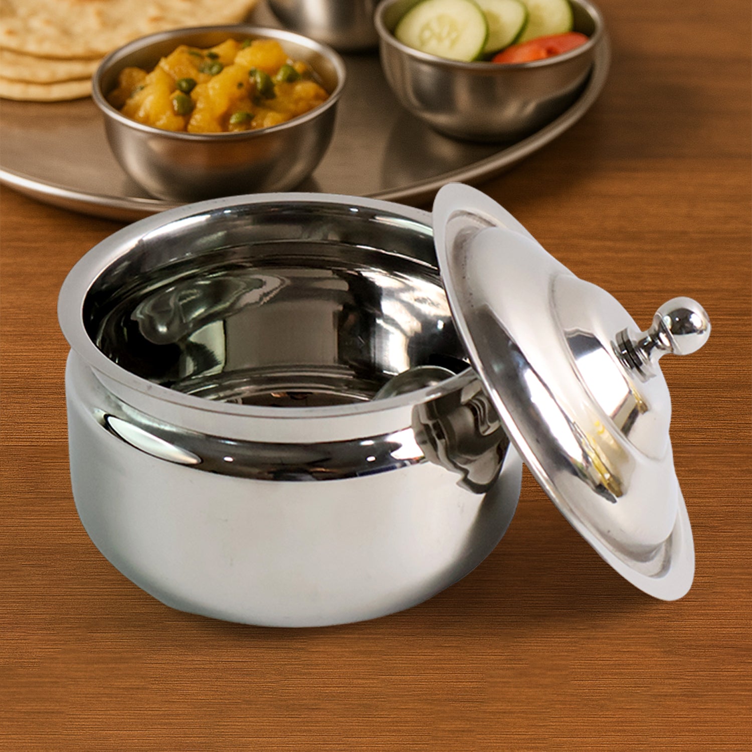 Wukusy premium stainless steel ghee pot with a lid, suitable for kitchen use and cooking traditional Indian dishes.