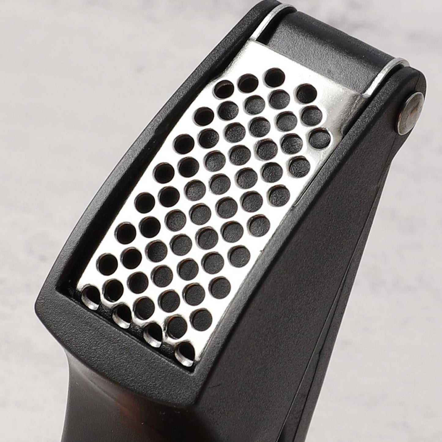Wukusy manual garlic press crusher tool showing stainless steel design for easy garlic mincing and crushing.