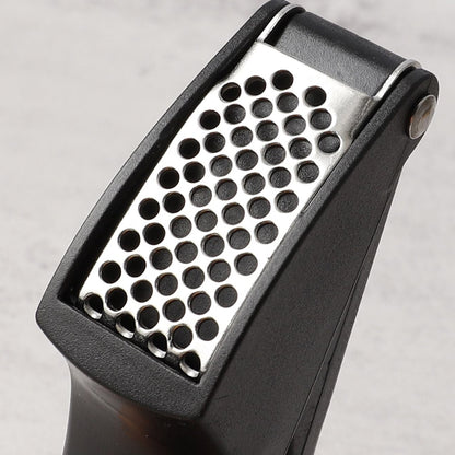 Wukusy manual garlic press crusher tool showing stainless steel design for easy garlic mincing and crushing.