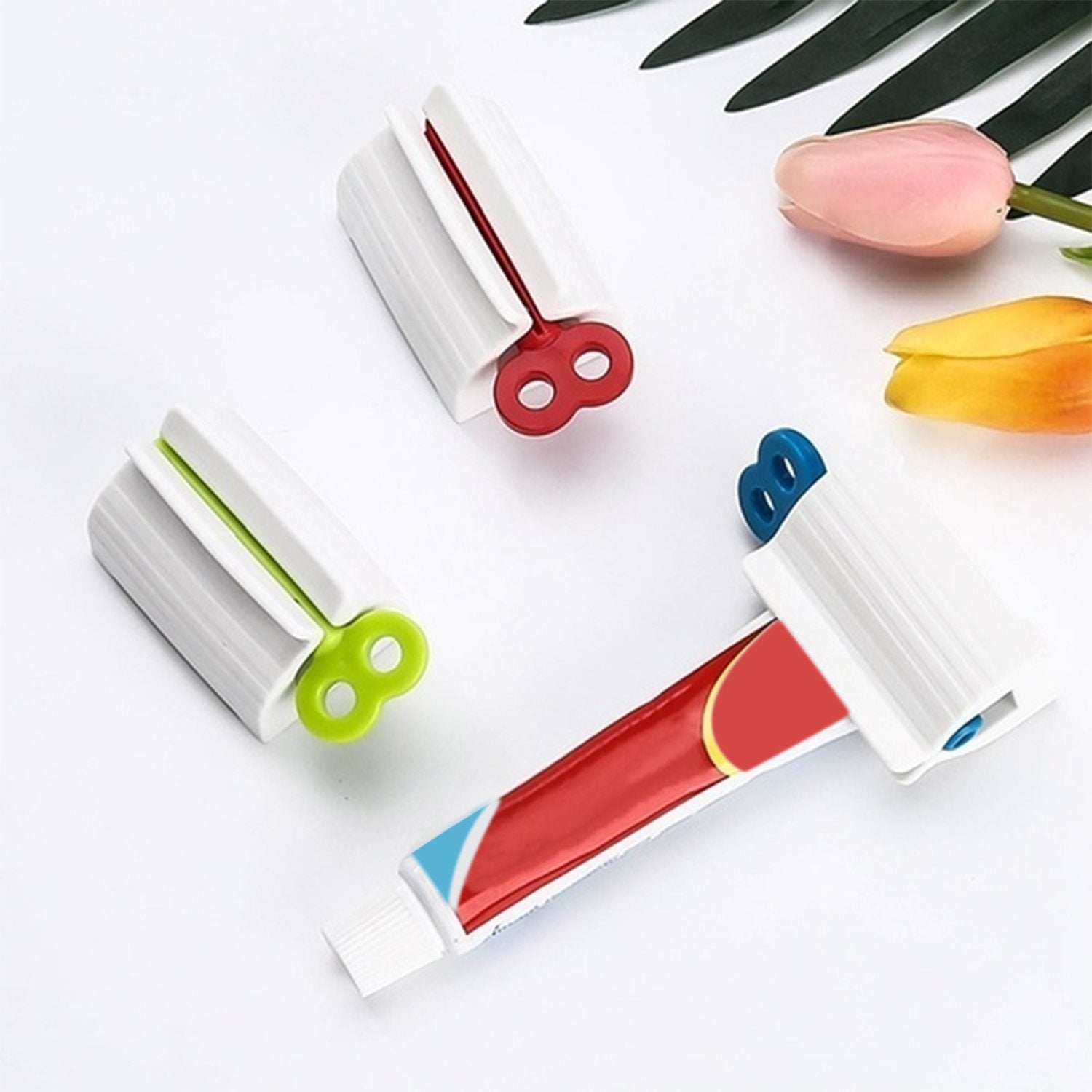 Wukusy 2514 rolling tube toothpaste squeezer and holder stand on bathroom countertop showing its compact design and functionality.
