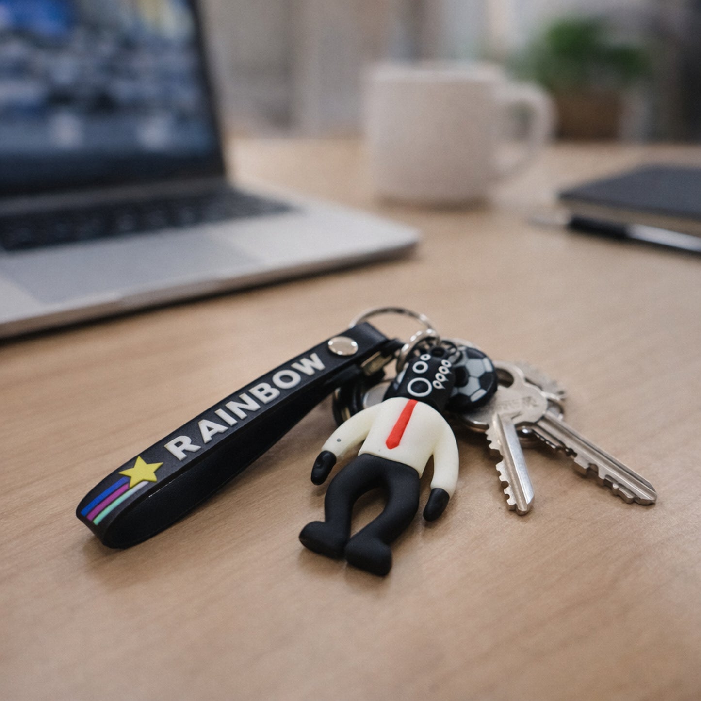 Colorful cartoon football boy keychain with rainbow strap from Wukusy, featuring a playful football-themed character.