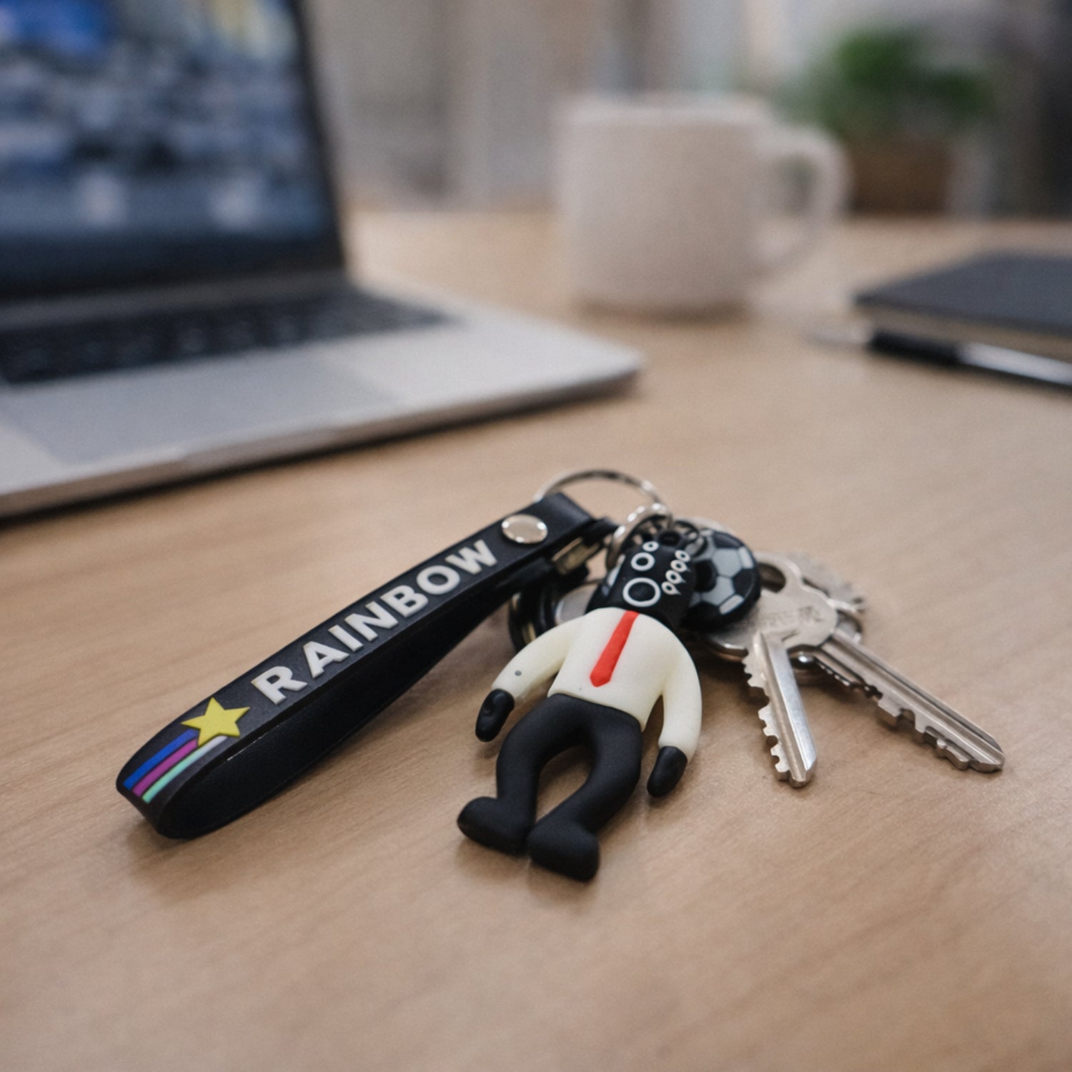 Colorful cartoon football boy keychain with rainbow strap from Wukusy, featuring a playful football-themed character.