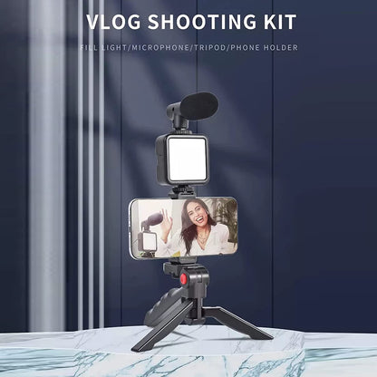 Wukusy 6054 vlogging kit with mini tripod, LED light, phone holder, and microphone for mobile video creation.