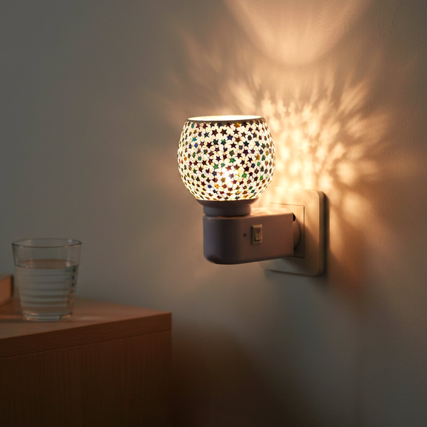 Wukusy decorative star pattern mosaic glass plug-in night lamp showcasing colorful star designs on a clear glass surface.