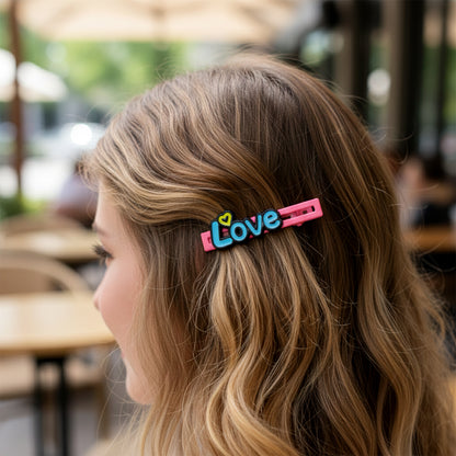 Set of four decorative Wukusy hair clips featuring floral and geometric designs on metal and plastic bases.
