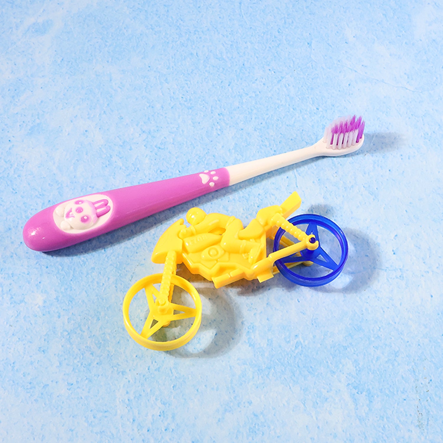 Wukusy kids toothbrush and bike toy set with colorful toothbrush and small bike toy for children, bright and playful design