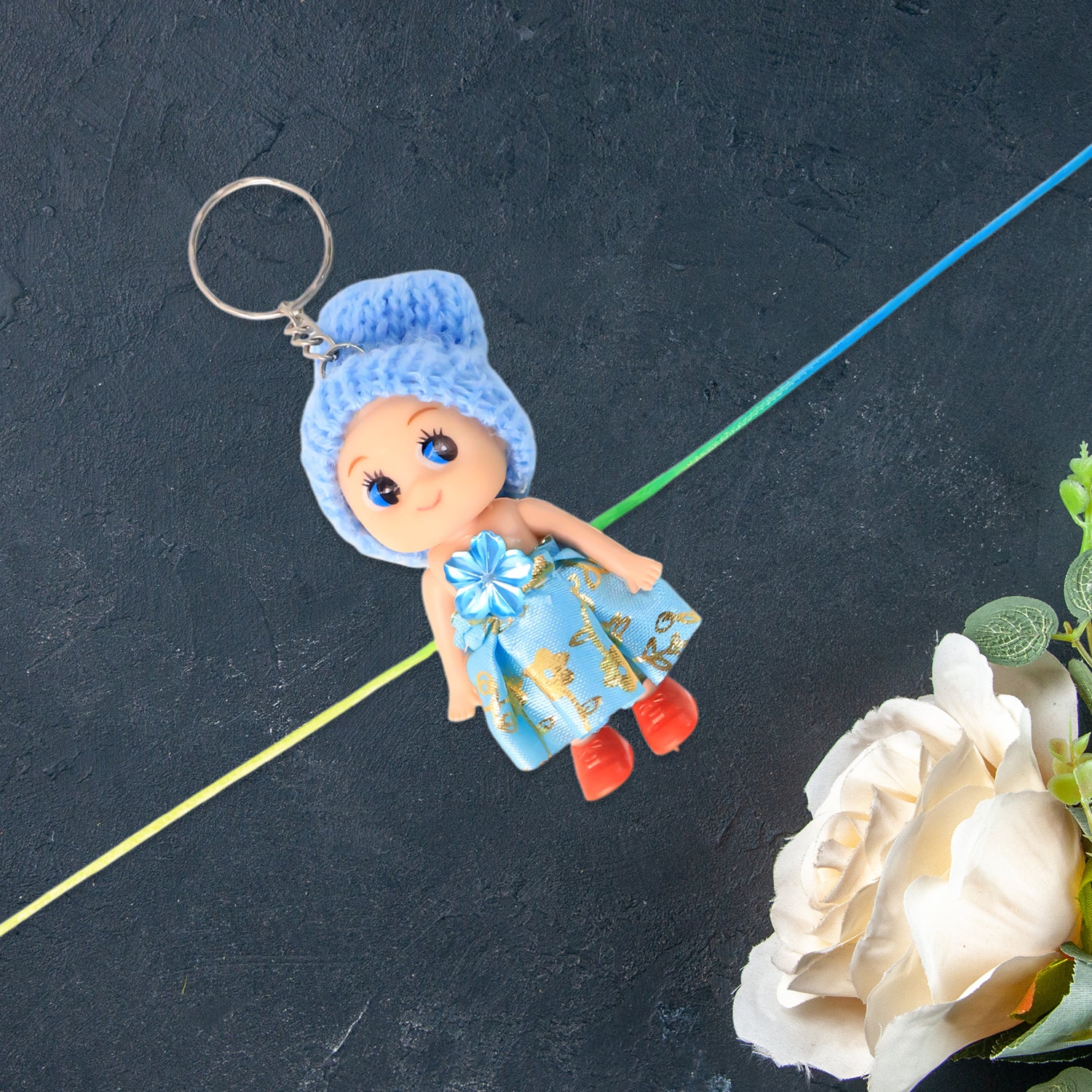 Soft toy doll rakhi with keychain for kids, featuring colorful decorative design by Wukusy, suitable for boys and girls.