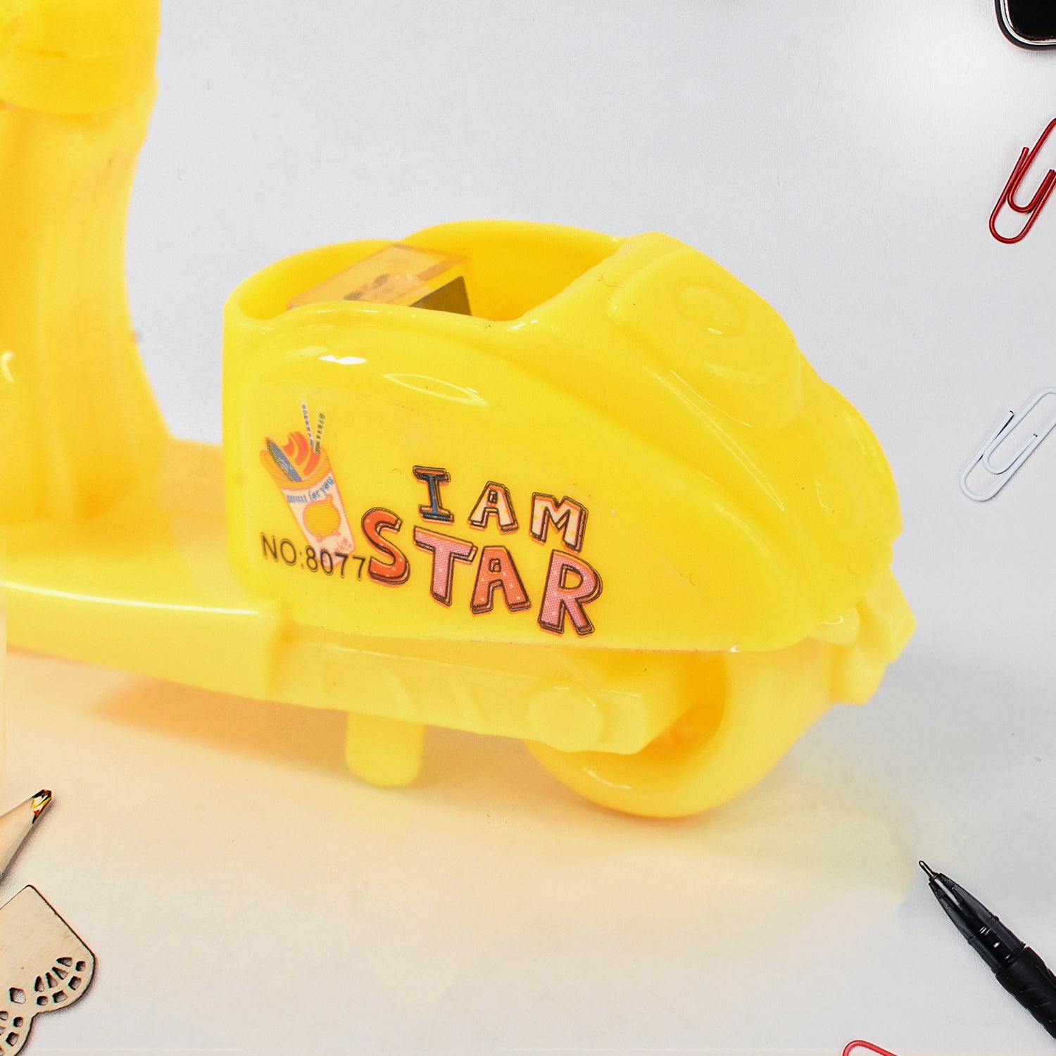 Wukusy bike-shaped pencil sharpener, a fun and unique stationery accessory for creative workspaces on an office desk.