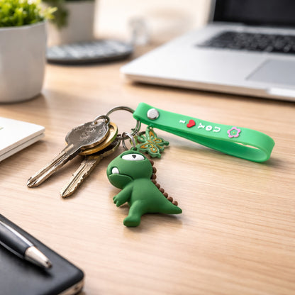 Cute Wukusy dinosaur cartoon keychain with silicone strap, featuring colorful dinosaur design and a metal keyring for keys or bags.