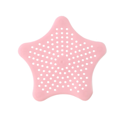 Baby pink silicone star-shaped sink filter by Wukusy, designed to catch hair and debris in bathroom basin drains.