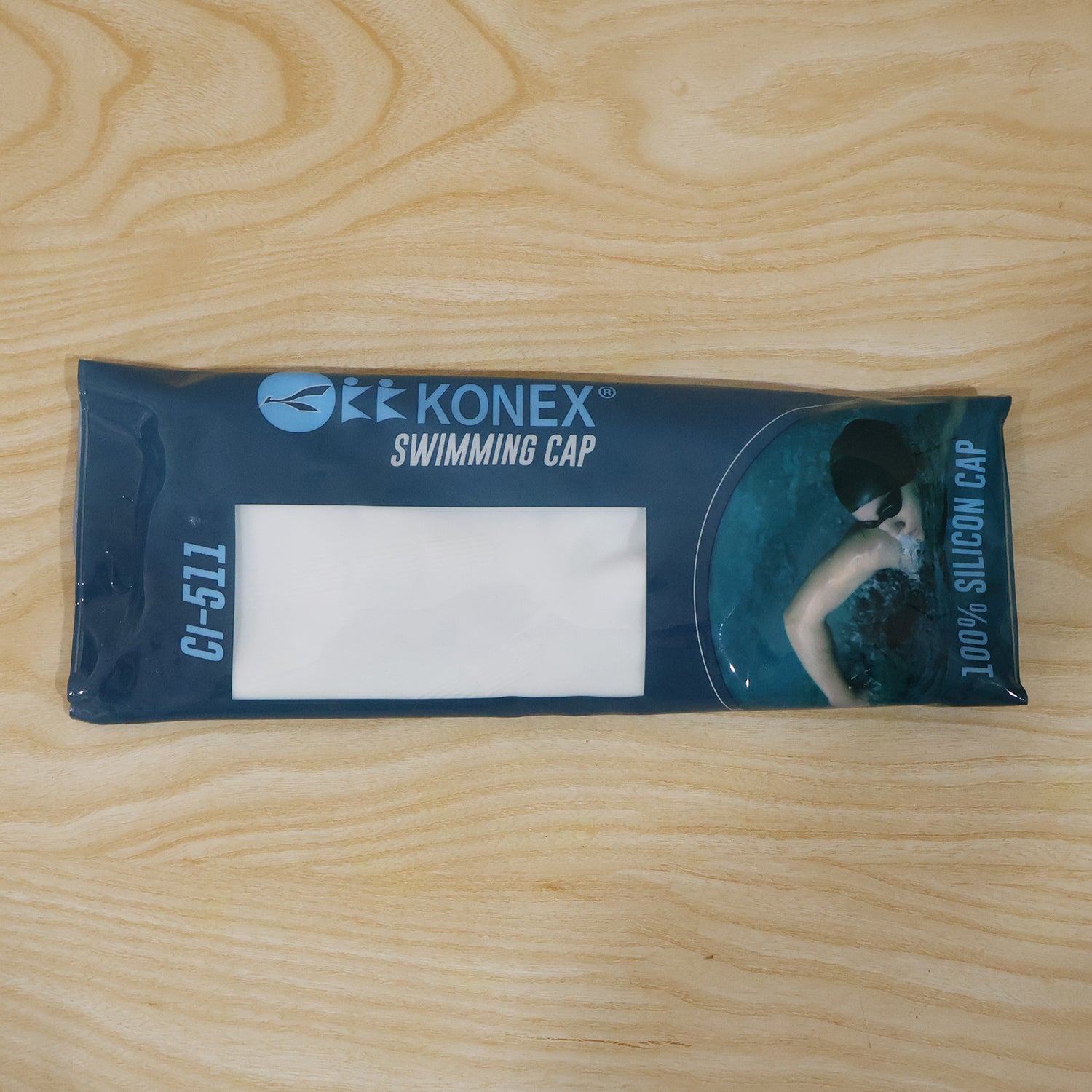Wukusy Konex flexible silicone waterproof swimming cap for adults and kids, shown in vibrant blue, fits snugly over head for water protection.