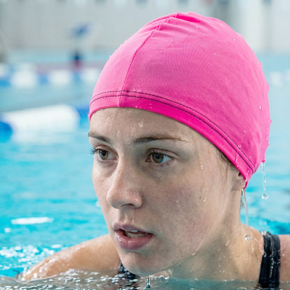 Small Wukusy premium stretchable swimming cap, close-up showing snug fit and smooth fabric for water sports and swimming.