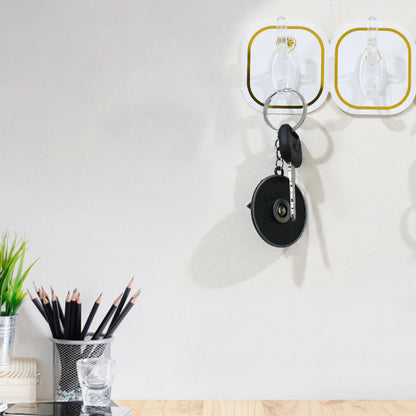 Six transparent adhesive wall hooks from Wukusy, ideal for home improvement, mounted on a wall for hanging lightweight items.