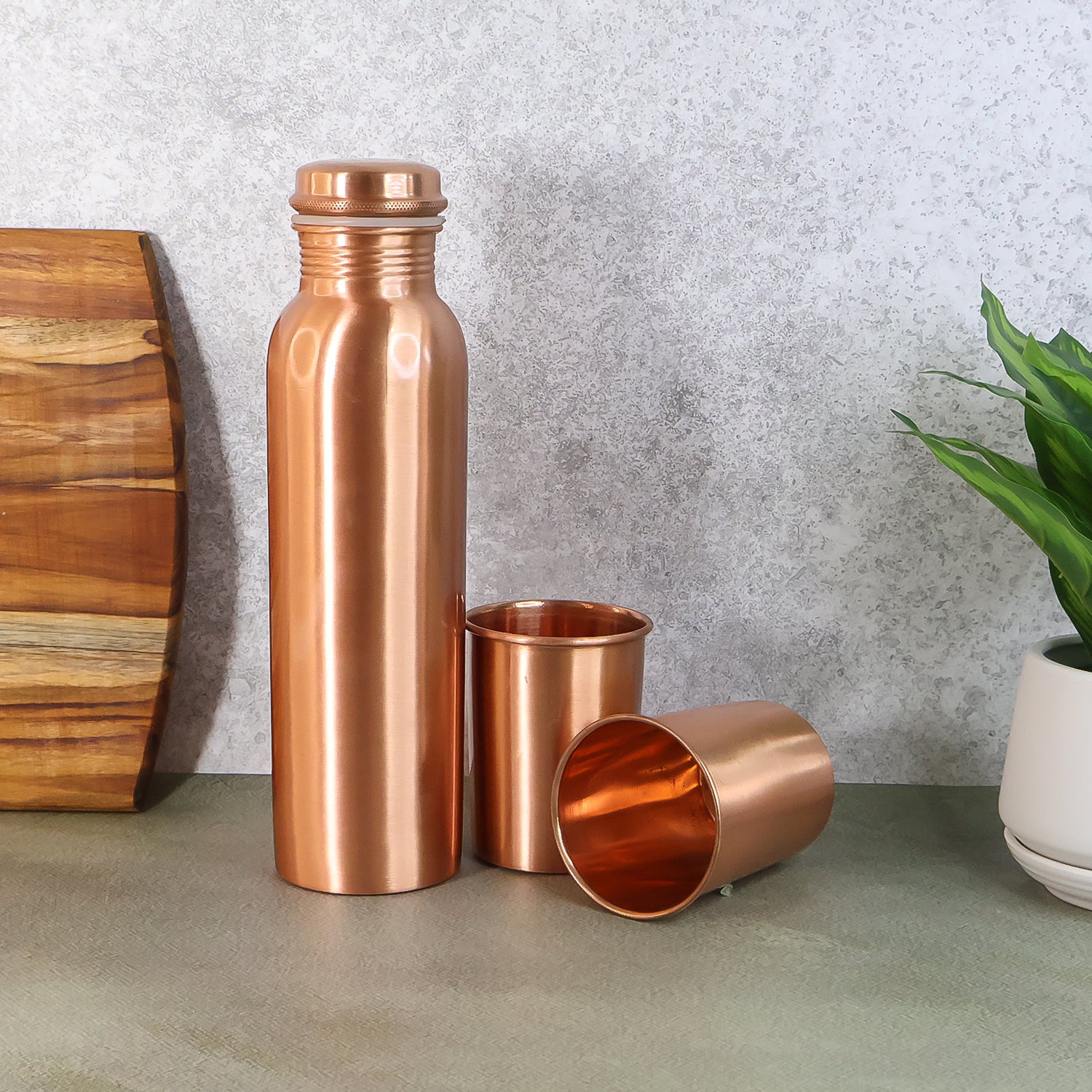 Wukusy copper water bottle with two glasses and gift box, 3-piece set, featuring shiny copper finish and elegant packaging.