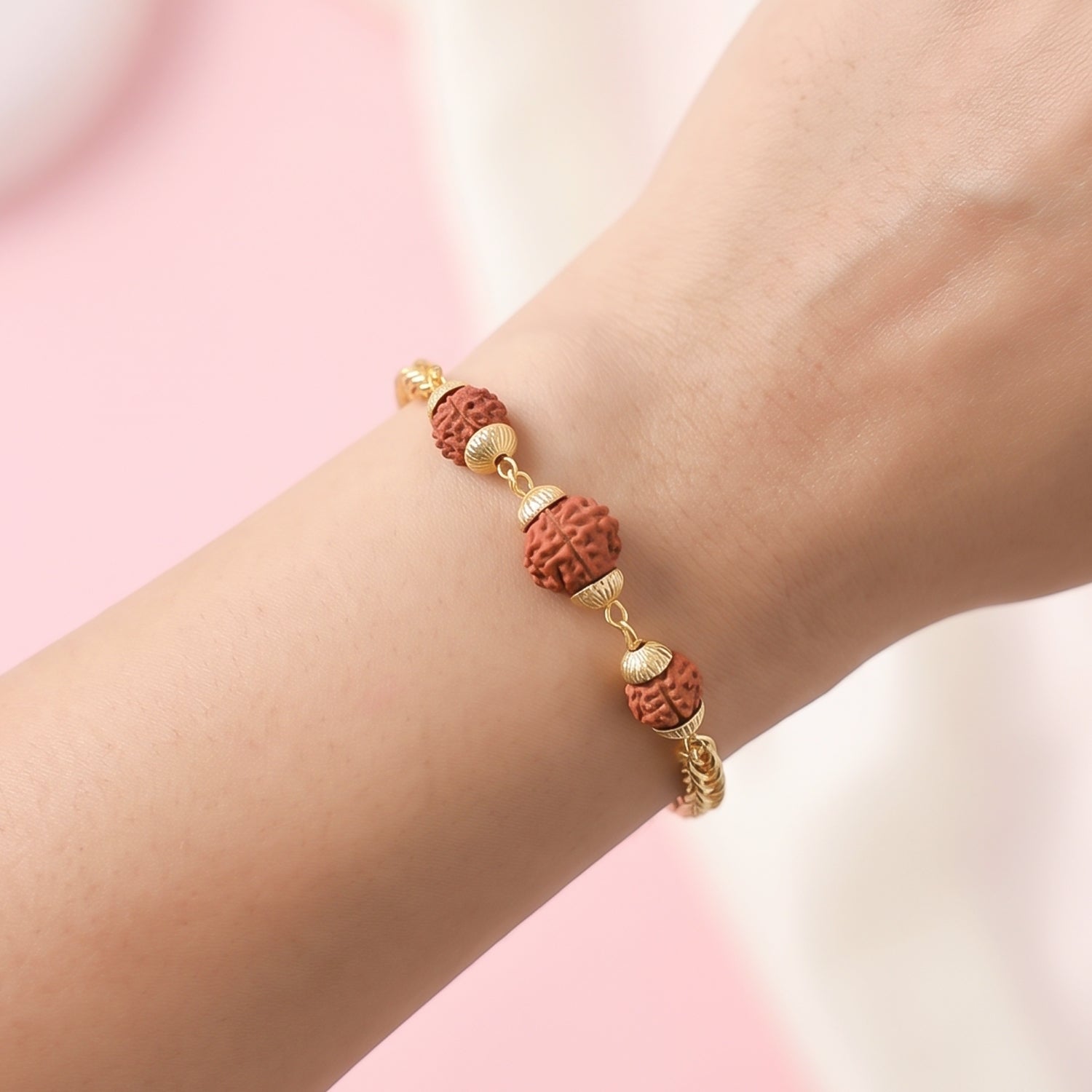 Gold-plated Rudraksha bead Rakhi with chain design for brother, featuring intricate craftsmanship and traditional style.