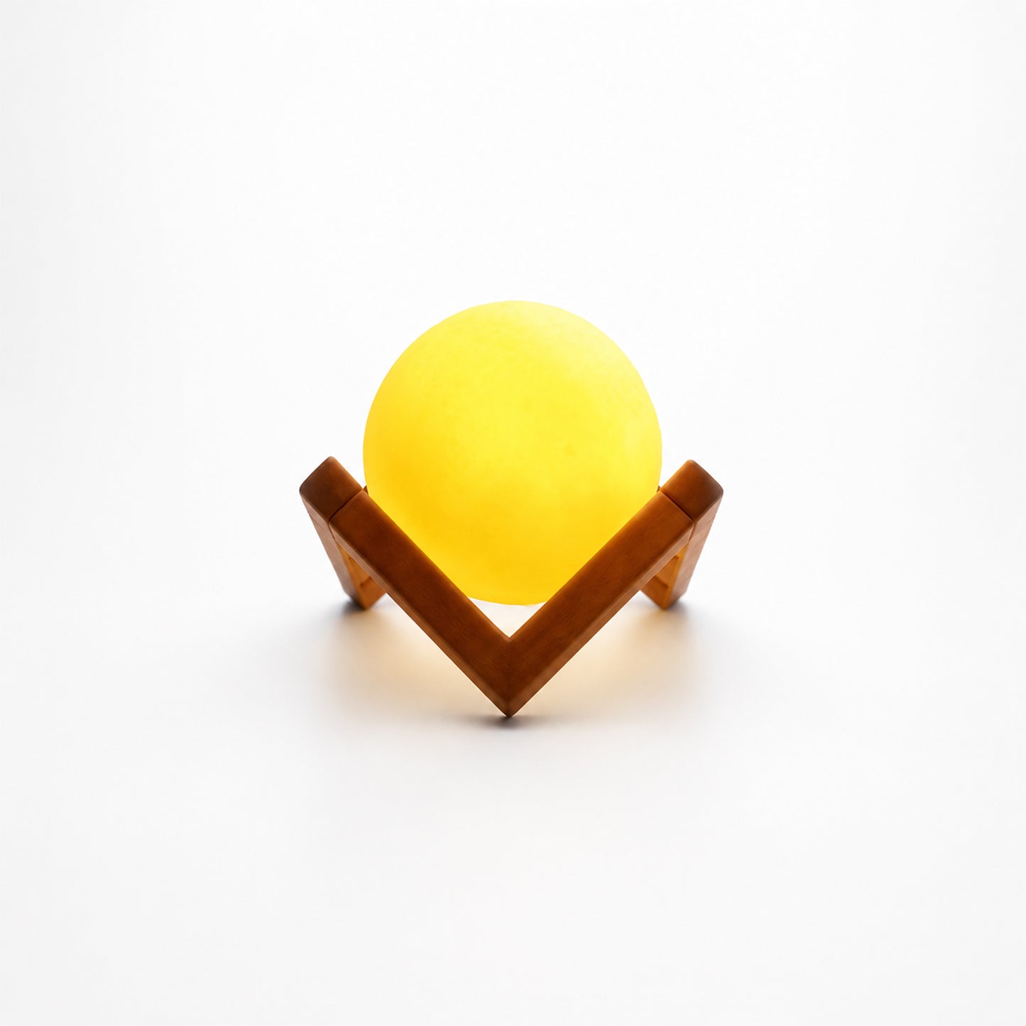 Wukusy LED ball night lamp with wooden stand, illuminated and glowing softly on a dark background.