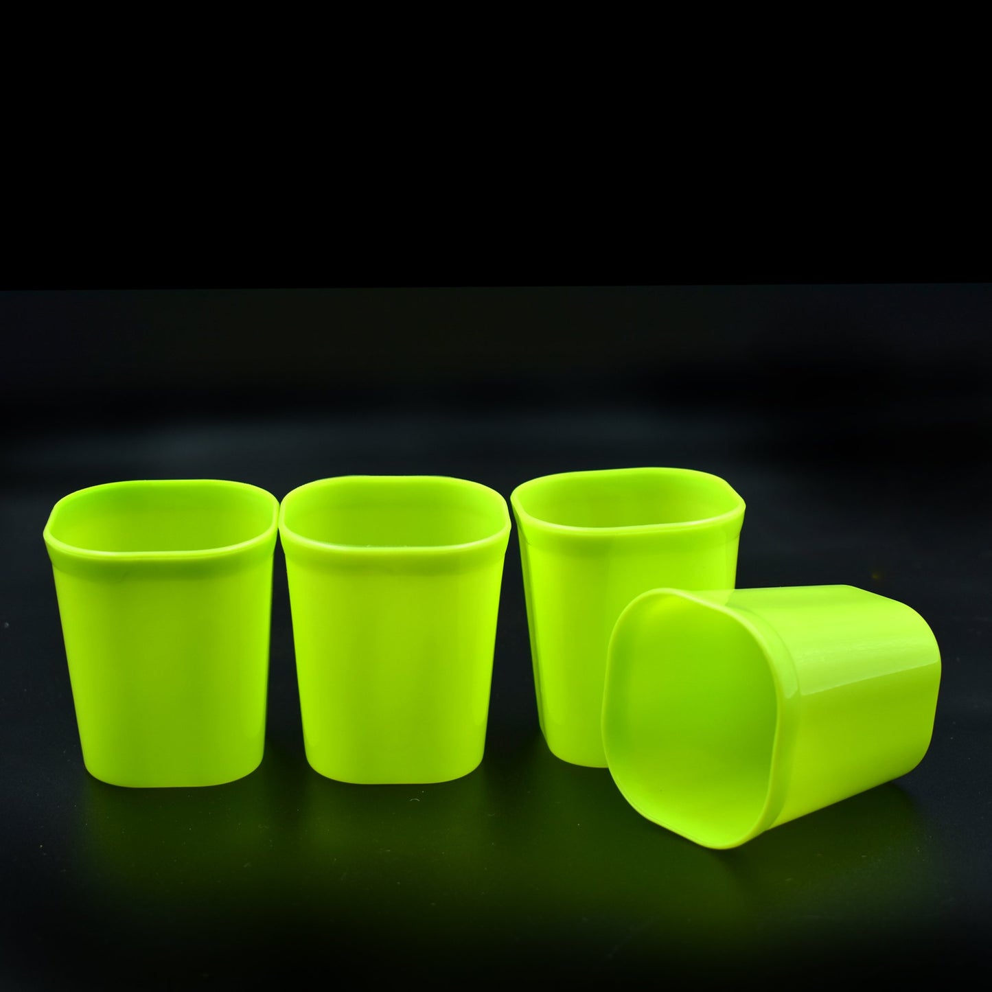 Set of four Wukusy plastic drinking glasses for milk, water, and juice in a home and kitchen setting.