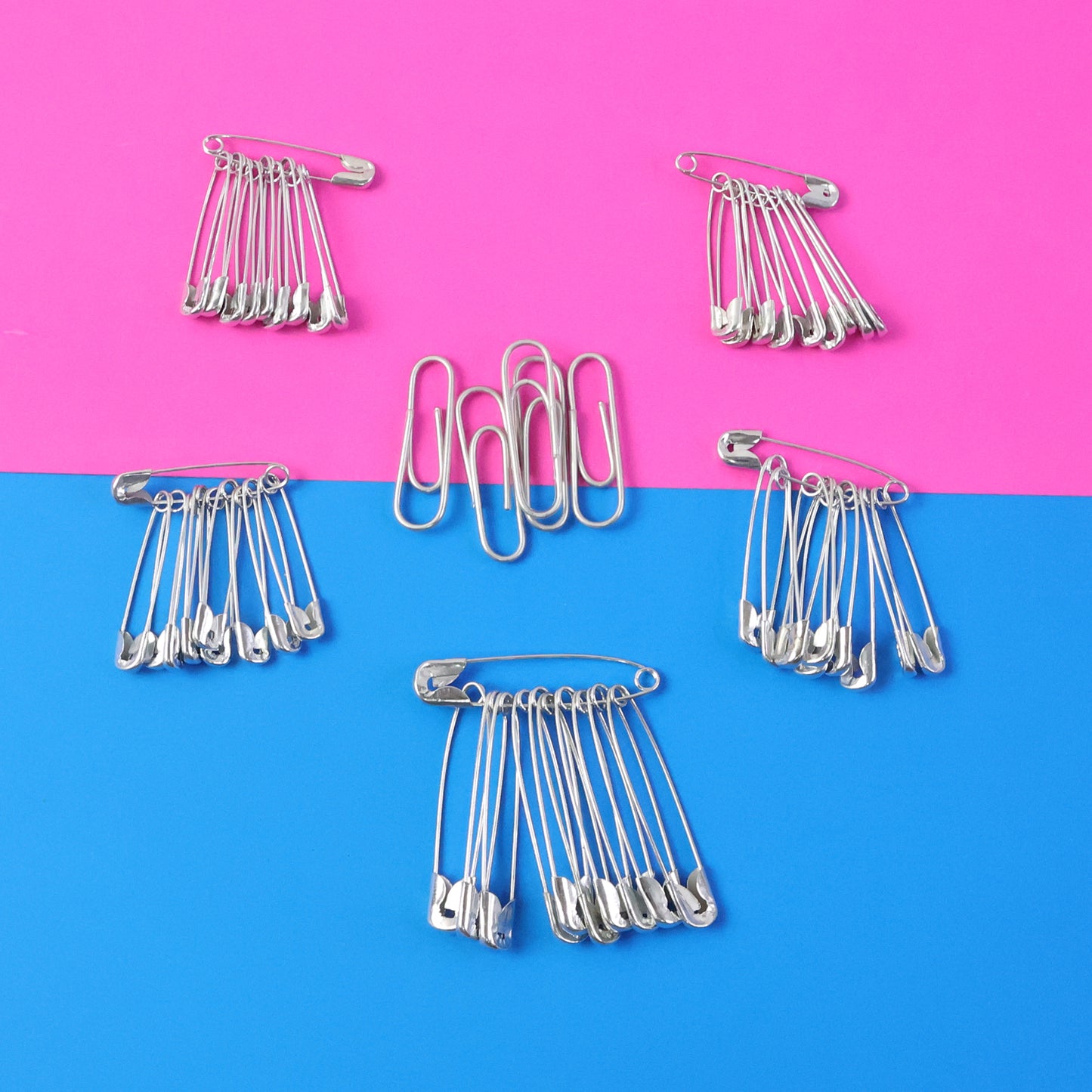Set of assorted metal safety pins in various sizes, displayed on a white background, from Wukusy's multipurpose safety pin collection.